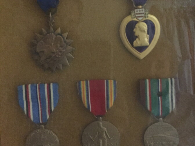 Medals awarded to James Gregory for his service in World War 2. Upper row (l-r): Air Medal, Purple Heart. Bottom row (l-r): American Campaign Medal, World War 2 Victory Medal, European-African-Middle Eastern Campaign Medal. 	