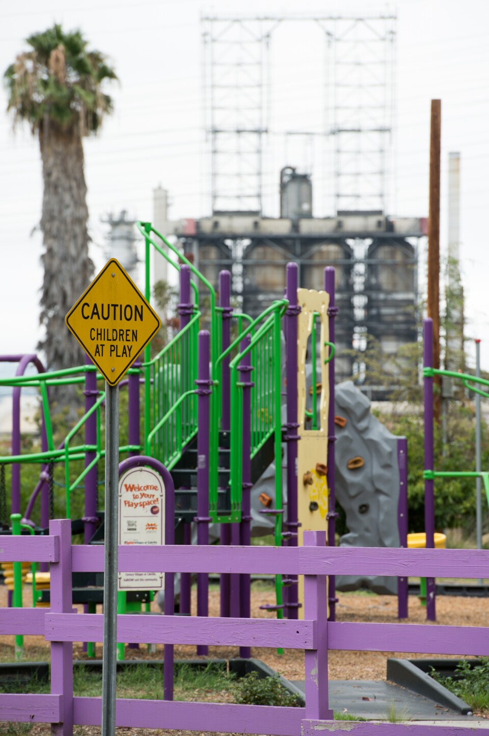 An oil refinery and highway are visible over the fence of a Long Beach child care center. KPCC reporters Deepa Fernandes and Sarah Monte investigate the effect of air pollution on early childhood development by taking air quality readings outside of child care centers located in Los Angeles County.