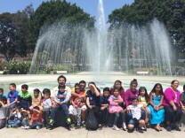 Janitors and their children at the Rose Garden fountain outside the California Science Center. The families attended a field trip on Sunday May 3, 2015, as part of an initiative by the UCLA Labor center and the janitor's union, SEIU United Service Worker's West to help janitors better understand the benefits of early education and navigate the system. 