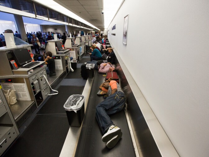 Paul Brown sleeps on a conveyor belt at LAX after the shooting on November 1st, 2013.