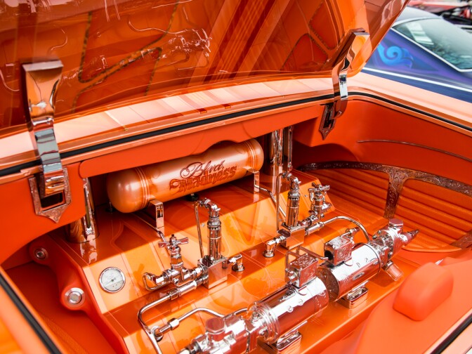 The trunk of Jesse Saldana's 1965 Chevrolet Impala Super Sport is home to the hydraulic pumps that make its chassis move up and down.