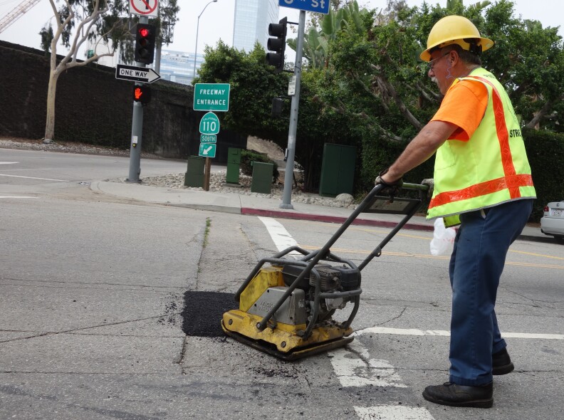                               City worker Hugo Vasquez uses a Wacker (yes, that's its brand name) to compact hot asphalt into a pothole.