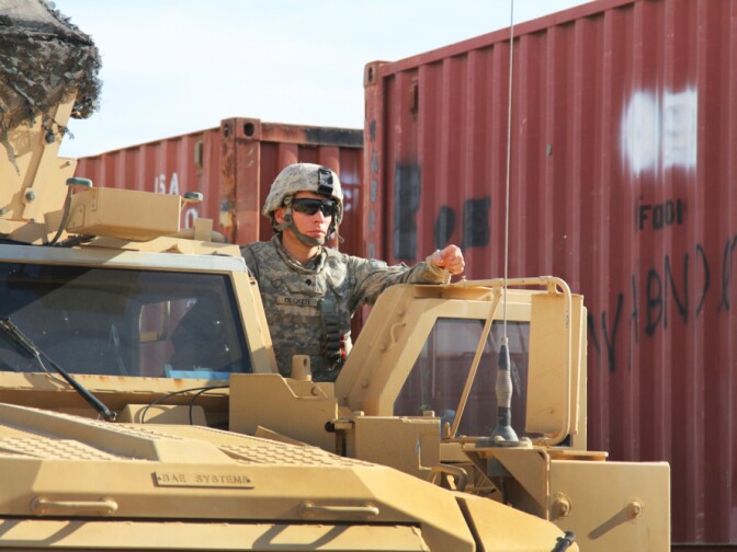  A driver of an armored vehicle  waits for fuel. More than 30,000 troops have passed through the Kalsu base as the U.S. shutters its military bases in Iraq.
