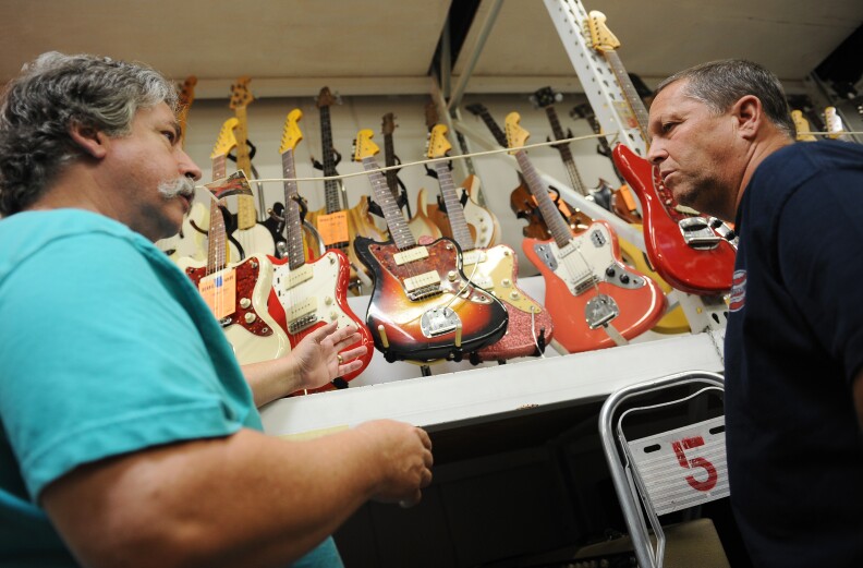 Jim Elyea (L), owner of the History for Hire prop house, help property master Mike Sexton (R) choose vintage Fender guitars for Clint Eastwood's upcoming film 'Jersey Boys,' August 9, 2013 in North Hollywood, California. Elyea's 32,000-square-foot (2973 square-meter) warehouse is stocked with hundreds of thousands of props spanning several eras, some originals and other recreations built to order onsite at Elyea's custom shop. 
