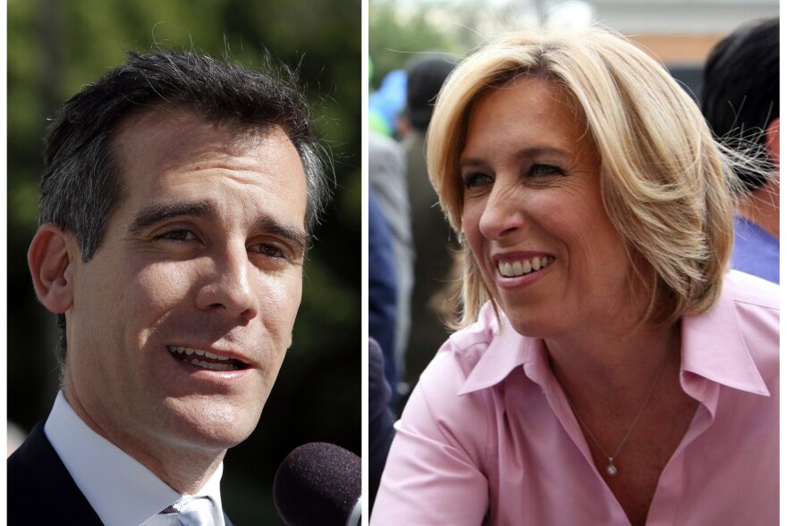This combo shows a Feb. 20, 2013 file photo of Los Angeles mayoral candidate Eric Garcetti speaking to media in Los Angeles, left, and undated image provided by the Wendy Greuel Campaign of mayoral candidate Greuel meeting with voters.