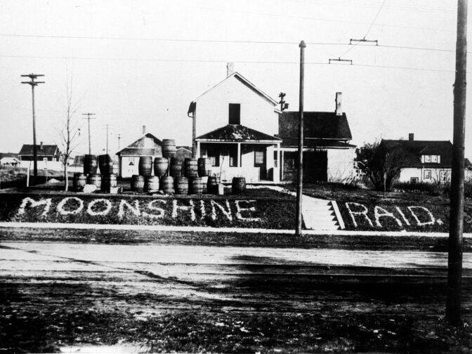 circa 1925: Barrels lined up by the side of a road in an American town where alcohol was found and confiscated during the Prohibition.