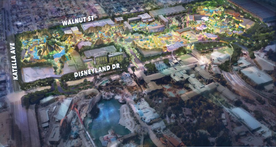 A computer generated visual of a theme park lit up in the middle with green, gold and purple.