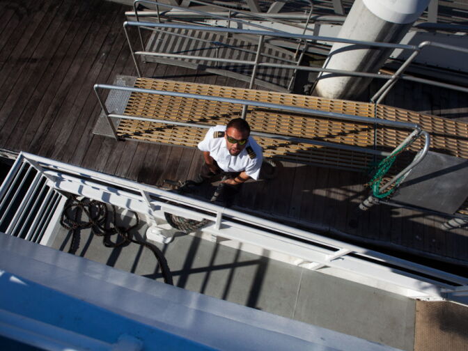 A crew member from the The Aquarium of the Pacific gets ready to take off on a Harbor Breeze Cruise for whale watching.