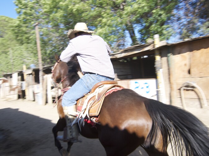 Cesar Ruvalcaba barrels down the lane near the stables.