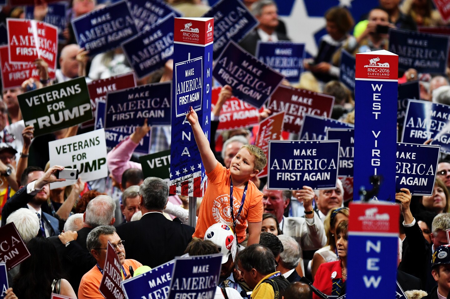CLEVELAND, OH - JULY 20:  Delegates hold up signs that read "Make America First Again" during the opening of the third day of the Republican National Convention on July 20, 2016 at the Quicken Loans Arena in Cleveland, Ohio. Republican presidential candidate Donald Trump received the number of votes needed to secure the party's nomination. An estimated 50,000 people are expected in Cleveland, including hundreds of protesters and members of the media. The four-day Republican National Convention kicked off on July 18.  (Photo by Jeff J Mitchell/Getty Images)