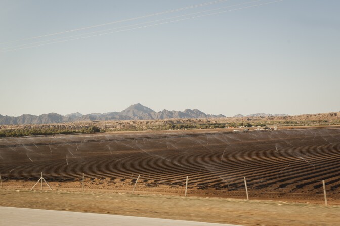 Sprinklers irrigate agricultural land on the Fort Yuma Indian Reservation, which is dominated by farmland. The Quechan Tribe is using a new tax credit program to fund construction of a 42-unit affordable housing project.  