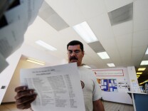 George Hernandez looks at job openings at the Foothill Employment and Training Connection in Pasadena earlier this year. The Labor Department said Thursday that the number of Americans seeking unemployment benefits jumped by 16,000 last week, the second straight weekly increase, But the longer-term trend in layoffs remained consistent with an improved job market.
	
