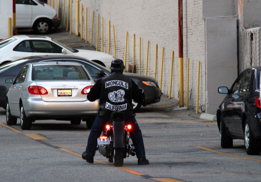 File: A member of the Mongols motorcycle club rides through downtown Los Angeles