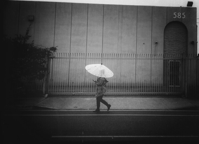 A stock photo of a woman walking on a rainy day in L.A.