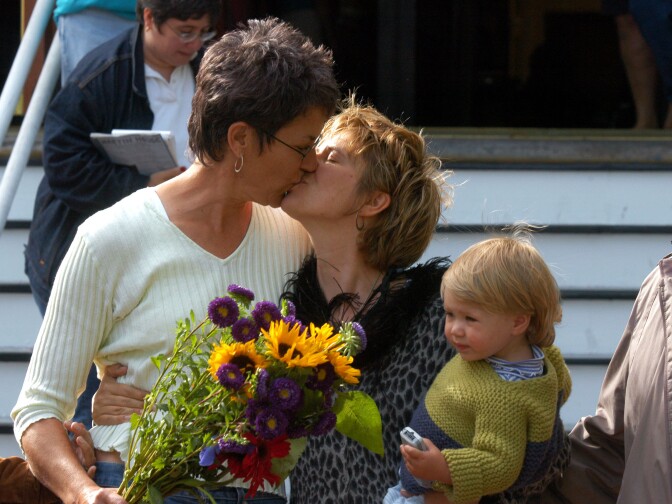 Suzanne Rotondo of New York holds daughter Phoebe while kissing Kristi Habedanck after they receive a marriage license in Provincetown, Mass., on May 17, 2004.