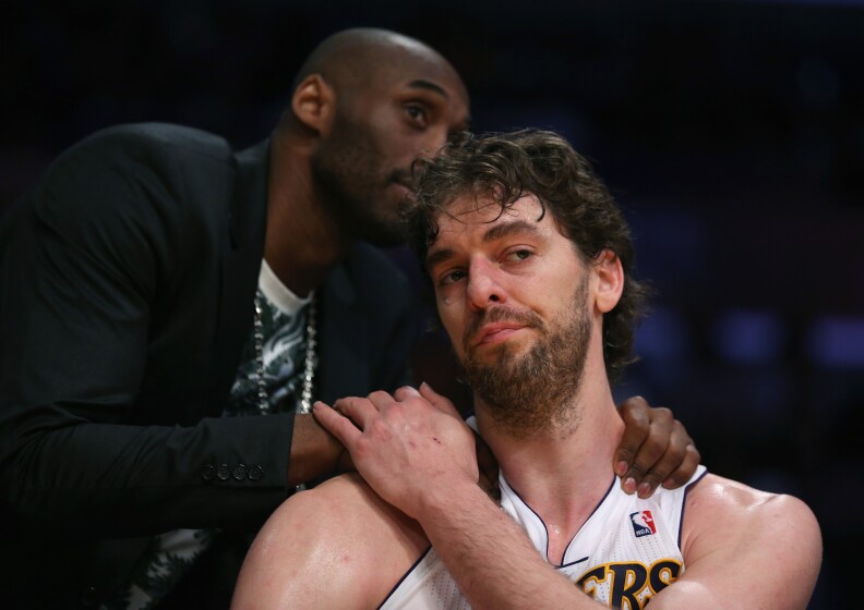 Pau Gasol #16 of the Los Angeles Lakers is consoled by Kobe Bryant after coming out of the game in the second half against the San Antonio Spurs during Game Four of the Western Conference Quarterfinals of the 2013 NBA Playoffs at Staples Center on April 28, 2013 in Los Angeles, California. The Spurs defeated the Lakers 103-82.  