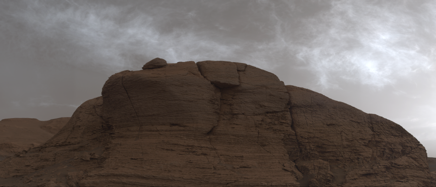 Cloudy skies above a cliff on Mars.