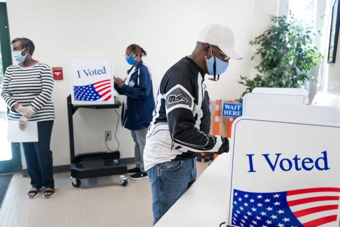 COLUMBIA, SC - OCTOBER 06: People their cast ballots at the Richland County Voter Registration & Elections Office on the second day of in-person absentee and early voting on October 6, 2020 in Columbia, South Carolina. Polling places have opened in several counties for voters to return their absentee ballots and vote early ahead of Election Day on November 3. (Photo by Sean Rayford/Getty Images)