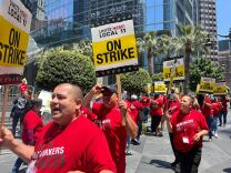  Striking hotel workers hold signs while working the picket lines outside of the InterContinental Hotel in Downtown L.A. on July 2, 2023. 