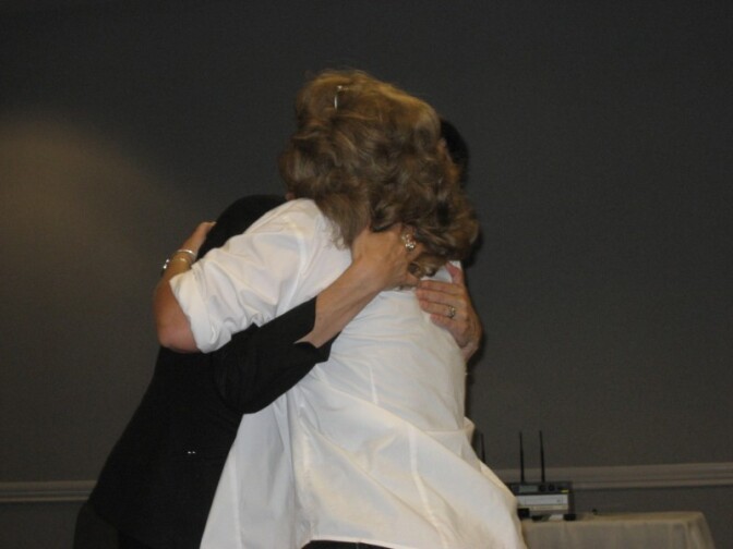 Rocio Watson os the Women's Transitional Living Center in Orange County hugs domestic violence survivor Brenda Clubine after a recent screening of the documentary "Sin by Silence" in Anaheim.