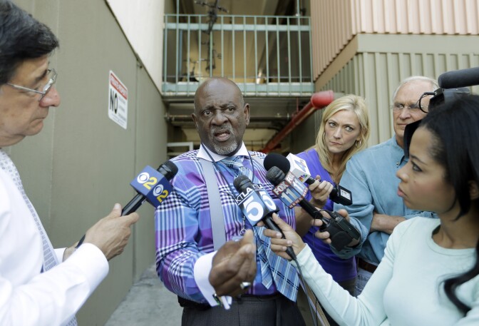 Rev. Eddie Royal Sr., who said he was the case manager for Nna Alpha Onuoha, 29, a TSA screener who has been charged with making threats to Los Angeles International Airport, talks with reporters after authorities searched an apartment said to belong to Onuoha at a veterans residence facility run by the Department of Veterans Affairs, in Inglewood, Calif., Wednesday, Sept. 11, 2013.  Onuoha was charged in federal court Wednesday with one count each of making a false threat and making threats affecting interstate commerce. (AP Photo/Reed Saxon)