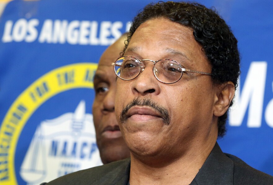 In this photo taken April 28, 2014, Leon Jenkins, president of the Los Angeles chapter of the NAACP, announces that Los Angeles Clippers basketball team owner Donald Sterling will not be receiving his lifetime achievement award, at a news conference in Culver City, Calif. Jenkins has his own legal problems, which are coming into focus now that the NBA has banned Sterling for racist comments.