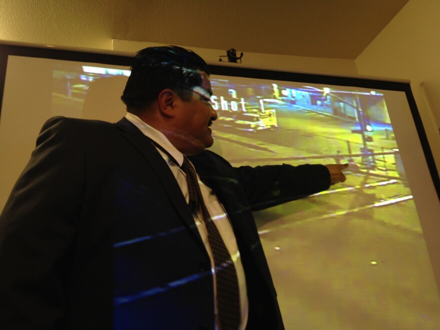 James Segall Gutierrez, attorney for the family of Jonathan Cuevas, 20, points to the corner of the street in a video clip that shows an LA County Sheriff's deputy shooting Cuevas. 

