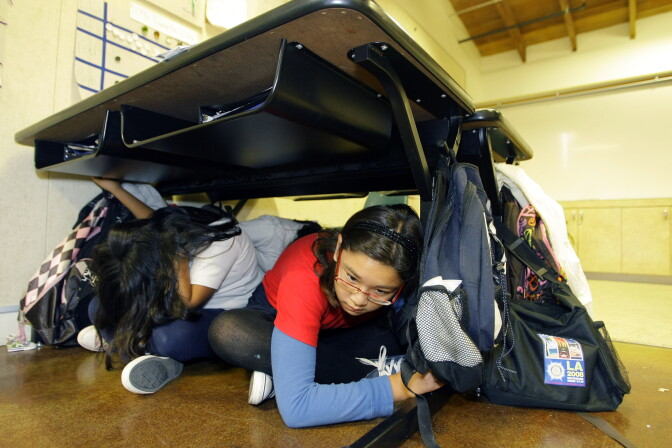 Children participate in the "Great California ShakeOut" earthquake drill at the Para Los Ninos Elementary School in Los Angeles on Thursday, Oct. 15, 2009. Participants are urged to drop, cover and hold on, the recommended procedure to protect oneself from falling objects in an earthquake, according to the recommendations by the Earthquake Country Alliance.