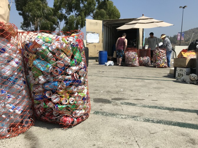 Customers sort bottles and cans at a recycling center in Eagle Rock, Aug. 8, 2019. (David Wagner/KPCC) 
