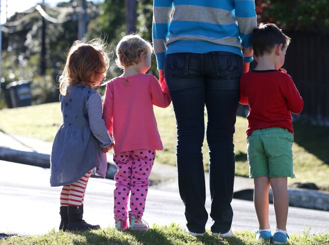 AUCKLAND, NEW ZEALAND - MAY 13:  Children walk alongside an adult on May 13, 2014 in Auckland, New Zealand. Finance Minister Bill English will deliver the federal budget on Thursday and is expected to announce a surplus and approximately $NZD 1 billion in new spending. Parents may benefit from extra paid parental leave, which has been tipped for inclusion in the 2014 budget announcement. (Photo by Fiona Goodall/Getty Images)