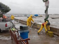 Newport Beach workers pump water that overtopped the seawalls on Balboa Island on Dec. 22, 2010. High tides and storm surges occasionally cause flooding on the island, but sea level rise threatens to make it a more frequent phenomenon. The city plans to extend the island's seawalls by 9 inches as a short-term fix. 