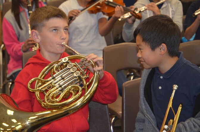 Anaheim City School District elementary students test out their instruments. Organizers of the new orchestra program estimate that the district still needs about 700 instruments to be fully stocked. 