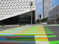 The four cross crosswalks in front of The Broad Museum are home to an exhibit by Venezuelan artists Carlos Cruz-Diez.