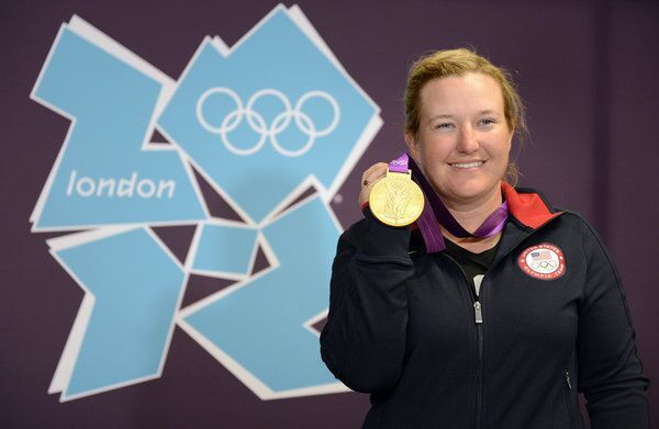 Shooter, Kim Rhode, smiles as she celebrates yet another victory in the Olympics.