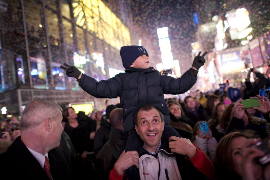 NEW YORK, NY - JANUARY 01:  Luis Tito, 6, celebrates atop the shoulders of his father, Jorge Tito, in Times Square just after the annual ball drop January 01, 2011 in New York City. This year a 11,875-pound Waterford crystal ball descended a 141-foot tall flagpole to mark the beginning of 2011.  (Photo by Brian Harkin/Getty Images) *** Local Caption *** Jorge Tito;Luis Tito