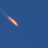 This frame grab from video by Haberturk TV, shows a Russian warplane on fire before crashing on a hill as seen from Hatay province, Turkey, Tuesday, Nov. 24, 2015.