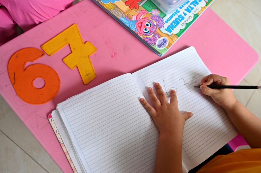 A girl attends a class at home in Cali, Colombia, on August 4, 2020. - The "teacher at home" modality implemented by a local kindergarten seeks to help children keep in touch with teachers and reduce the emotional impact due to isolation during the pandemic. (Photo by LUIS ROBAYO / AFP) (Photo by LUIS ROBAYO/AFP via Getty Images)