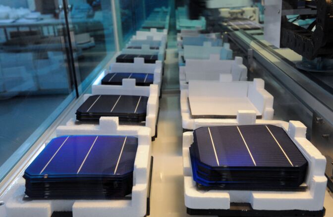 Photovoltaic cells are displayed on an assembly line at MPO Energy plant in Averton, western France, on January 7, 2013.
