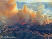 An aerial image shows the North Fire burning near homes in the Santa Clarita area
