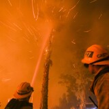 Firefighters battle a wildfire as it burns along a hillside near homes in Santa Paula, California, on December 5, 2017.
Fast-moving, wind-fueled brush fire exploded to about 10,000 acres in Ventura County Monday night, forcing hundreds of people to flee their homes, officials said.  / AFP PHOTO / RINGO CHIU        (Photo credit should read RINGO CHIU/AFP/Getty Images)
