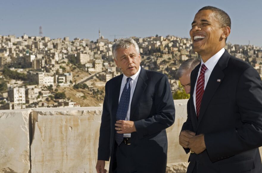 US Democratic presidental candidate Barack Obama (R) shares a laugh with US Senator Chuck Hagel R-Neb., as they tour the Citadel on July 22 2008, with the hillsides of Amman in the background. Illinois Senator Obama continues his tour across the Middle East and then on to Europe. US Senator Jack Reed D-R.I., is obscured in the center.  AFP Photo/Paul J. Richards (Photo credit should read PAUL J. RICHARDS/AFP/Getty Images)
