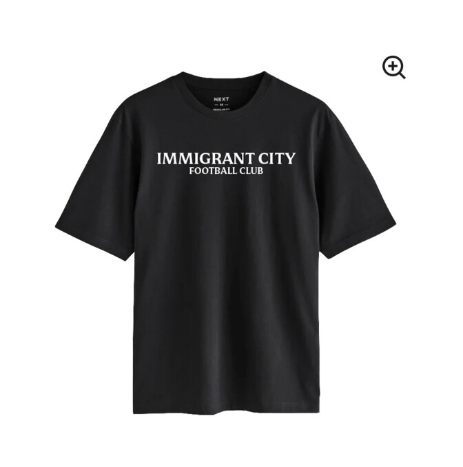 A black t-shirt has white lettering that reads: 'Immigrant City Football Club' 