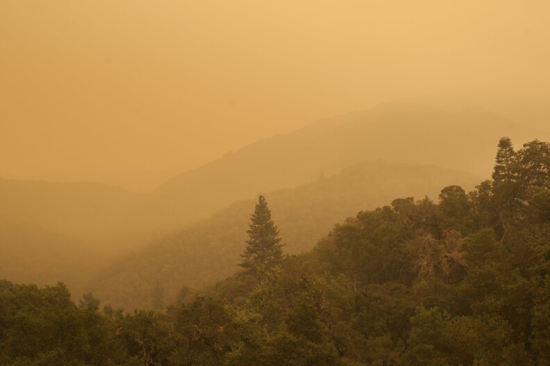 Smoke from a wildfire spreads over woods, as seen from White Rock in Carmel Valley, southeast of Monterey, Calif., Wednesday, July 27, 2016. Acting Gov. Tom Torlakson, substituting for Gov. Jerry Brown who is at the Democratic National Convention with other top state officials, declared a state of emergency for the fire and another wildfire outside of Los Angeles on Tuesday night. The move frees up funding and relaxes regulations to help with the firefight and recovery. (AP Photo/Nic Coury)