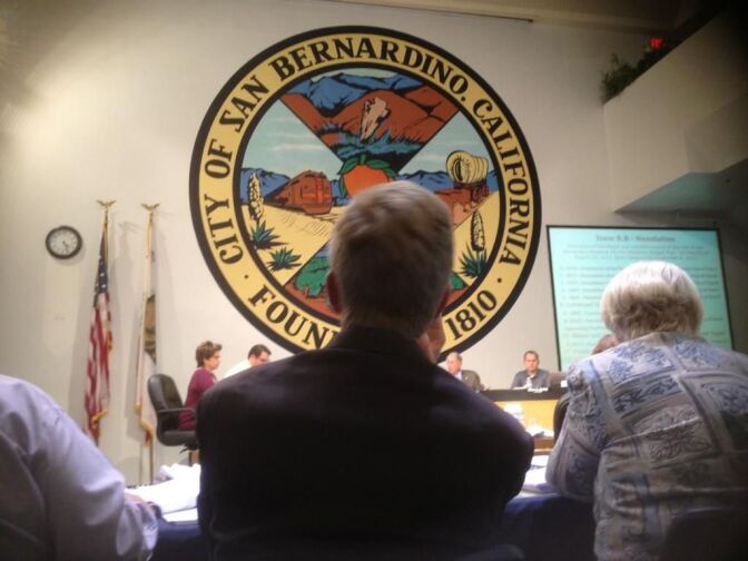 KPCC's Steven Cuevas sits behind the finance chiefs at Wednesday night's San Bernardino council hearing. 