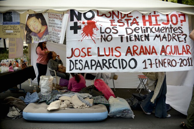 Part of a group of mothers taking part in a hunger strike are seen in a tent in front of the Attorney General building in Mexico City on May 9, 2013. The mothers are demanding that the government investigate the disappearance of their children, which they say have gone missing due to the drug war that the government started in 2006.