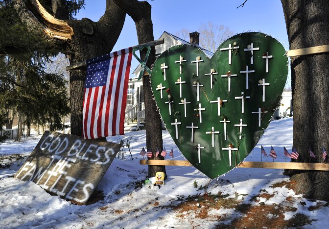 Some of the remaining memorial items to Sandy Hook Elementry students and staff who died are viewed in Newtown, Connecticut on January 3, 2013. Students at the elementary school where a gunman massacred 26 children and teachers last month were returning Thursday to classes at an alternative campus described by police as 'the safest school in America.' Survivors were finally to start their new academic year in the nearby town of Monroe, where a disused middle school has been converted and renamed from its original Chalk Hill to Sandy Hook. 