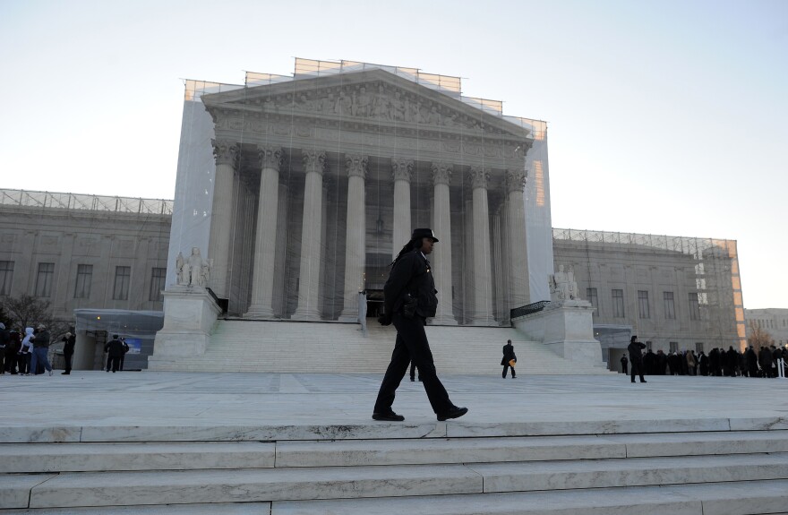 A policewoman stands at her post in front of the Supreme Court on March 27, 2013 in Washington, DC.
