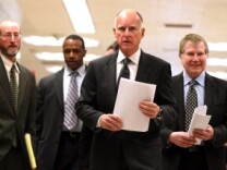 Gov. Jerry Brown walks with advisors to a press conference about his proposed budget at the California State Capitol on Jan. 10, 2011 in Sacramento.