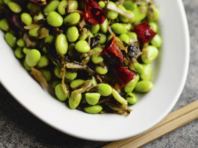 Young soybeans, often known as edamame, are firmer than peas. Cookbook author Fuchsia Dunlop says they make an easy and delicious dinner when stir-fried.