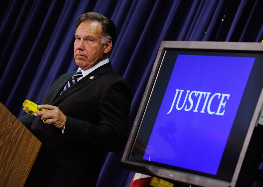 SANTA ANA , CA - SEPTEMBER 21:  Orange County District Attorney Tony Rackauckas holds a taser gun as a prop during a news conference to announce that two Fullerton, California police officers were charged in connection with the death of  Kelly Thomas, a schizophrenic homeless man who died after the altercation with several police officers, on September 21, 2011 in Santa Ana, California. Officer Manuel Ramos was charged with second-degree murder and involuntary manslaughter, while Cpl. Jay Cicinelli was charged with involuntary manslaughter and use of excessive force.  (Photo by Kevork Djansezian/Getty Images)